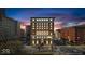 Striking exterior of a vintage brick building, illuminated by lights against the evening sky at 350 N Meridian St # 610, Indianapolis, IN 46204