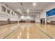 Full gymnasium featuring hardwood floors and blue accents, a basketball hoop, and abundant natural light at 350 N Meridian St # 610, Indianapolis, IN 46204