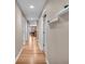 Hallway featuring wood floors, neutral walls, white doors and shelves, leading to dining area at 350 N Meridian St # 610, Indianapolis, IN 46204