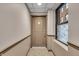 Hallway with carpeting, light walls, apartment entrance, and a window view at 350 N Meridian St # 610, Indianapolis, IN 46204