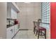 Modern kitchenette with white cabinetry, granite countertops, and stylish bar seating at 350 N Meridian St # 610, Indianapolis, IN 46204
