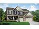 Charming two-story home with brick and siding, featuring a two-car garage and well-manicured lawn at 3587 Planck Cir, Danville, IN 46122