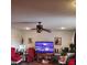 A home's open living room with large tv and a ceiling fan at 3701 N Audubon Rd, Indianapolis, IN 46218