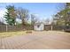 Wide backyard space with a wood deck and a storage shed at 4108 Carson Ave, Indianapolis, IN 46227