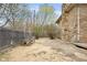 Wide backyard space featuring a wood deck, stone exterior, and a wooden fence at 4108 Carson Ave, Indianapolis, IN 46227