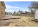 Wide backyard featuring a wooden deck, storage shed, and a stone exterior at 4108 Carson Ave, Indianapolis, IN 46227