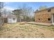 Wide backyard featuring a wood deck, storage shed, stone exterior, and a fire pit at 4108 Carson Ave, Indianapolis, IN 46227