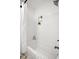 Bright bathroom featuring a white tiled shower and a tub with a shower curtain at 4108 Carson Ave, Indianapolis, IN 46227