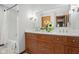 Bright bathroom featuring double sink vanity, stylish lighting, and a tub with shower at 4108 Carson Ave, Indianapolis, IN 46227