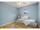 Bedroom with a ceiling fan, light blue walls, hardwood floors, and a light-colored rug at 4108 Carson Ave, Indianapolis, IN 46227