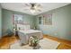Cozy bedroom with hardwood floors, neutral decor, and natural light from two windows at 4108 Carson Ave, Indianapolis, IN 46227
