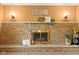 Close up of the stone fireplace featuring a stone mantle, brass doors, and natural decor at 4108 Carson Ave, Indianapolis, IN 46227