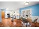 Bright kitchen features white cabinets, stainless steel appliances, wood floors, and a dining area with natural light at 4108 Carson Ave, Indianapolis, IN 46227