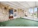 Enclosed sunroom with stone accents, multiple windows, and an entrance to the home's interior at 4108 Carson Ave, Indianapolis, IN 46227