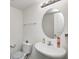 Cozy half-bathroom with a pedestal sink and a round mirror at 4135 Benicia Ln, Indianapolis, IN 46235