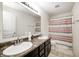 Bathroom with a double sink vanity, updated faucet fixtures, and a shower-tub combo with curtain at 4135 Benicia Ln, Indianapolis, IN 46235