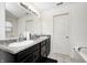 Bathroom featuring double sinks, granite countertops, and a separate bathtub at 4135 Benicia Ln, Indianapolis, IN 46235