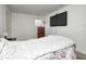 Bright bedroom featuring a large TV, wooden dresser and a comfortable bed, with lots of natural light at 4135 Benicia Ln, Indianapolis, IN 46235