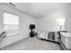 Bright bedroom with a large window, neutral carpet, TV on stand, and comfortable single bed at 4135 Benicia Ln, Indianapolis, IN 46235