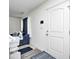 Entryway featuring a white door, and glimpses of the blue couch and the white walls at 4135 Benicia Ln, Indianapolis, IN 46235