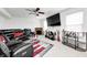 Open living room with a black leather couch, an electric fireplace, and a ceiling fan at 4135 Benicia Ln, Indianapolis, IN 46235