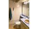 Classic bathroom with beige tiled walls, a peach-colored sink, and blue countertop details at 4214 Woodsage Trce, Indianapolis, IN 46237