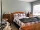 Cozy bedroom featuring a wooden bed frame with purple patterned linens and matching wooden nightstands at 4214 Woodsage Trce, Indianapolis, IN 46237