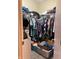 Walk-in closet with clothing on hangers and boxes on floor at 4214 Woodsage Trce, Indianapolis, IN 46237