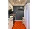 Functional kitchen with white cabinets and unique orange tiled floors at 4214 Woodsage Trce, Indianapolis, IN 46237