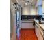 Galley kitchen features white cabinets, unique floors and stainless steel microwave at 4214 Woodsage Trce, Indianapolis, IN 46237