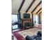 Cozy living room featuring a stone fireplace, large windows, and comfortable seating at 4214 Woodsage Trce, Indianapolis, IN 46237