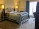 Bedroom with iron bed frame, carpet flooring and natural light at 4214 Woodsage Trce, Indianapolis, IN 46237