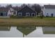 Rear exterior showcasing the home's backyard, deck, and privacy fence with lake views from the property at 462 N Crystal Dr, Fortville, IN 46040