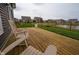 Backyard featuring a wooden deck, green grass, a pond, and view of neighborhood homes at 462 N Crystal Dr, Fortville, IN 46040