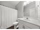 Well-lit bathroom with a single sink vanity, mirror, and shower with a curtain at 462 N Crystal Dr, Fortville, IN 46040