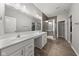 Bright bathroom with double sinks, a large mirror, and a tiled walk-in shower at 462 N Crystal Dr, Fortville, IN 46040