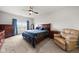 Comfortable bedroom with a wooden bed frame, a window view and a relaxing armchair at 462 N Crystal Dr, Fortville, IN 46040