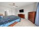 Spacious bedroom featuring wooden furniture, a ceiling fan, and a large window at 462 N Crystal Dr, Fortville, IN 46040