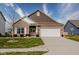 Charming single-Gathering home featuring a brick facade, landscaped yard, and attached two-car garage at 462 N Crystal Dr, Fortville, IN 46040
