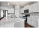 Bright kitchen featuring marble countertops, stainless-steel appliances, and modern fixtures at 462 N Crystal Dr, Fortville, IN 46040