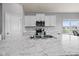 Modern kitchen with white cabinets, stainless-steel appliances, and a large countertop at 462 N Crystal Dr, Fortville, IN 46040