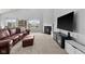 Bright living room with fireplace, leather sofa and ottoman, and big windows with a view at 462 N Crystal Dr, Fortville, IN 46040