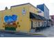 Exterior of a yellow restaurant with a sunflower mural and black awning at 462 N Crystal Dr, Fortville, IN 46040
