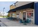 Outdoor seating at a restaurant with yellow and blue walls and a black awning at 462 N Crystal Dr, Fortville, IN 46040