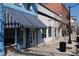 Street view of several storefronts with awnings and a barber shop with a blue and white striped awning at 462 N Crystal Dr, Fortville, IN 46040