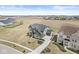 An aerial view of a beautiful gray brick two-story home with a long driveway at 4763 Denton Dr, Zionsville, IN 46077