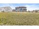 View of backyard and house featuring a gray exterior, large windows, and a well-maintained lawn at 4763 Denton Dr, Zionsville, IN 46077
