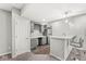 Basement bar with counter seating, cabinets, a mini-fridge, wine rack, and stylish lighting, offering a cozy entertainment space at 4763 Denton Dr, Zionsville, IN 46077