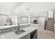 Basement bar area with a sink, marble countertops, and pendant lighting, perfect for entertaining guests at 4763 Denton Dr, Zionsville, IN 46077