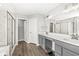 Well-lit bathroom with double vanity, gray cabinets, and glass shower at 4763 Denton Dr, Zionsville, IN 46077